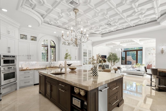 kitchen with an ornate ceiling, a notable chandelier, a sink, a warming drawer, and visible vents
