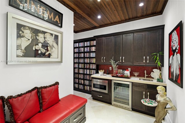 interior space with wood ceiling, bar area, beverage cooler, stainless steel microwave, and recessed lighting