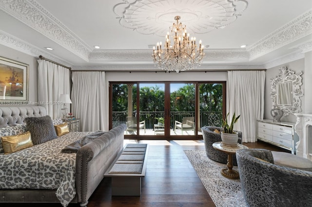 bedroom featuring a tray ceiling, access to exterior, french doors, and hardwood / wood-style floors