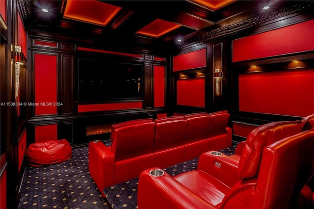 carpeted cinema featuring beam ceiling, coffered ceiling, and ornamental molding