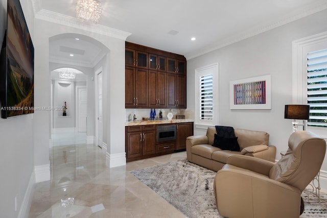 living room with ornamental molding, baseboards, marble finish floor, arched walkways, and a notable chandelier