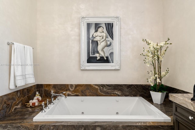 full bath with a tub with jets and vanity