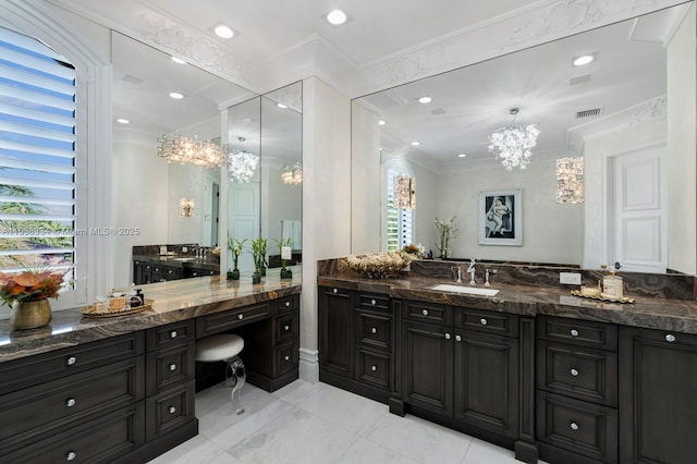 bathroom featuring visible vents, vanity, ornamental molding, and an inviting chandelier