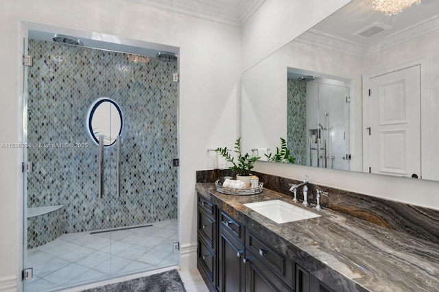 full bathroom featuring vanity, crown molding, a stall shower, and visible vents