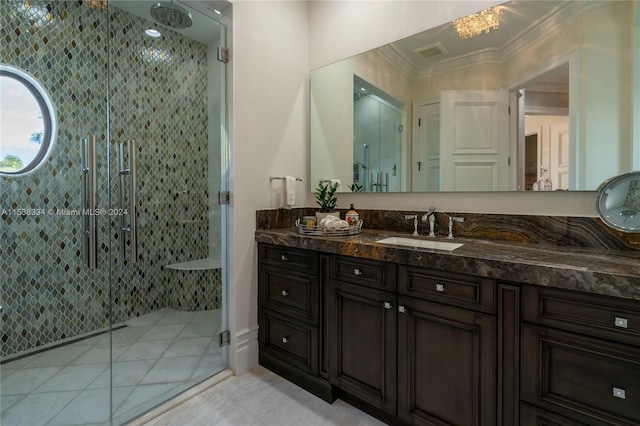 bathroom with tile patterned flooring, vanity, ornamental molding, and walk in shower