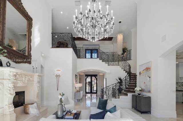 entrance foyer featuring a fireplace, arched walkways, crown molding, and stairs