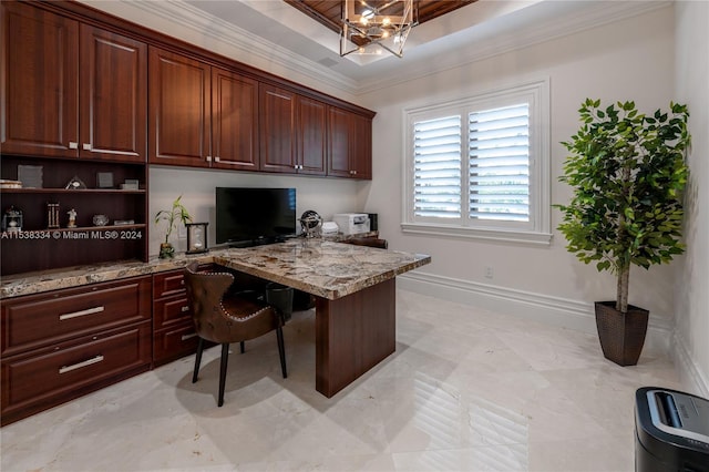 office area featuring a raised ceiling, built in desk, and ornamental molding