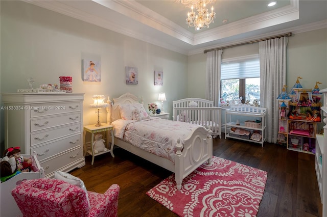 bedroom with a notable chandelier, dark hardwood / wood-style flooring, crown molding, and a tray ceiling