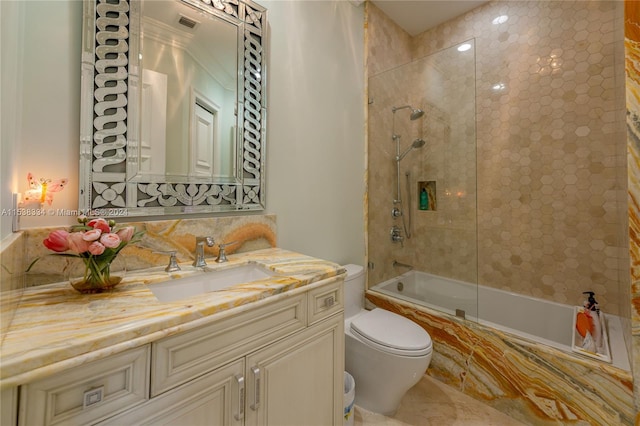 full bathroom featuring vanity, toilet, and tiled shower / bath