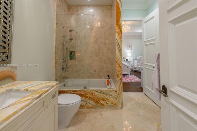 full bathroom featuring vanity, tiled shower / bath combo, toilet, and ornamental molding