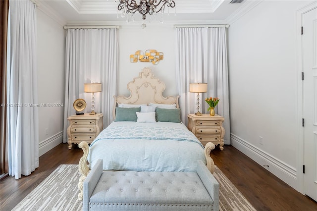 bedroom featuring dark wood-type flooring, an inviting chandelier, and crown molding