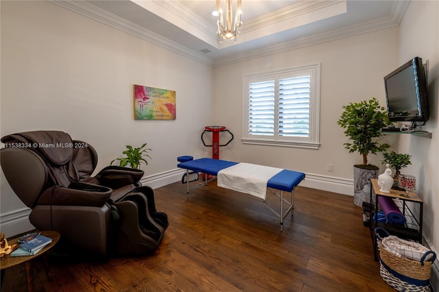 sitting room with a raised ceiling, crown molding, dark hardwood / wood-style flooring, and a notable chandelier