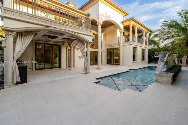 view of swimming pool featuring a patio area and ceiling fan