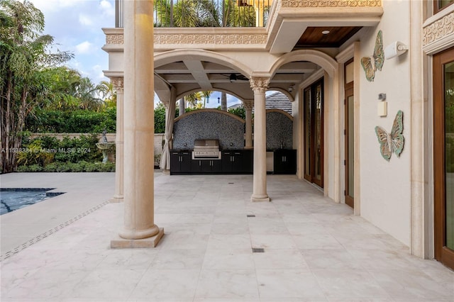 view of patio / terrace featuring an outdoor kitchen, a grill, and ceiling fan