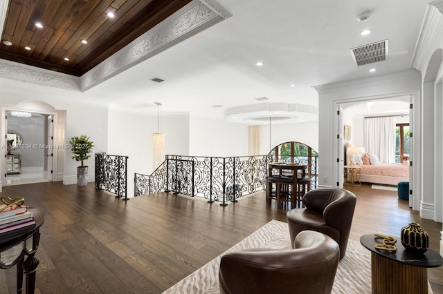 sitting room featuring an upstairs landing, visible vents, plenty of natural light, and hardwood / wood-style flooring