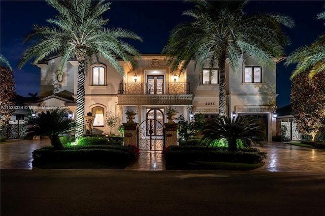 mediterranean / spanish home featuring a balcony and a garage