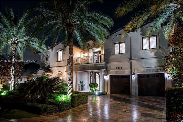 view of front facade with a garage and a balcony