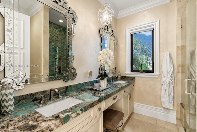 bathroom featuring tile patterned floors, crown molding, a sink, a shower stall, and baseboards