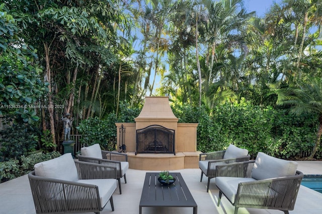 view of patio / terrace with an outdoor living space with a fireplace