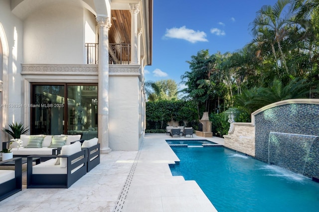 view of pool with a pool with connected hot tub, an outdoor hangout area, and a patio