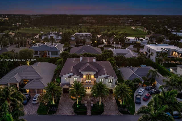 aerial view at dusk featuring a residential view