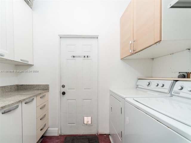 laundry room featuring cabinets and washing machine and dryer