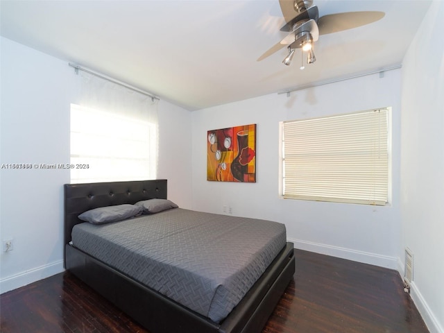 bedroom with ceiling fan and dark wood-type flooring