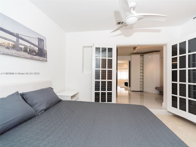 bedroom with light tile patterned floors and ceiling fan