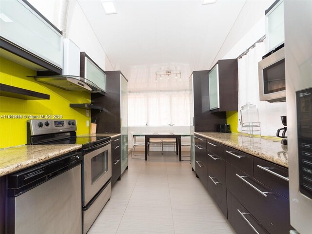 kitchen featuring light stone counters and appliances with stainless steel finishes