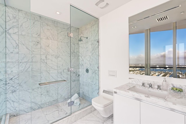 bathroom featuring toilet, a shower with shower door, oversized vanity, a water view, and tile floors