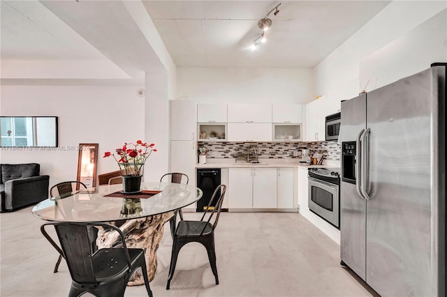 kitchen featuring white cabinets, light tile flooring, appliances with stainless steel finishes, and sink