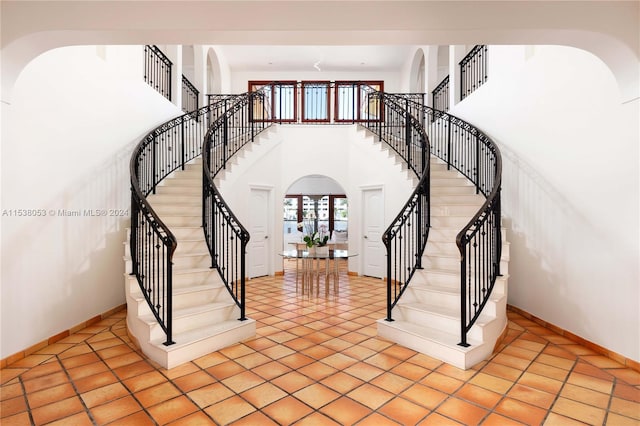 foyer with light tile patterned floors and a high ceiling