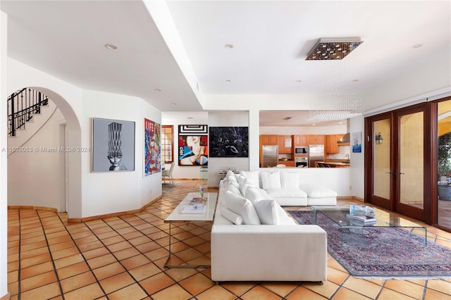 living room with french doors and light tile patterned floors