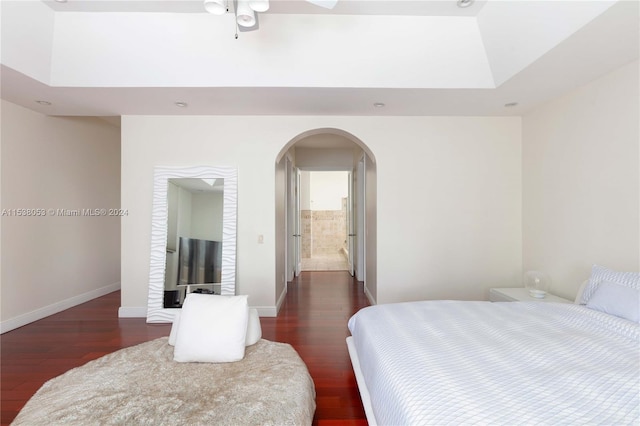 bedroom featuring dark hardwood / wood-style flooring and ensuite bath