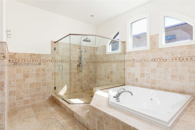 bathroom featuring separate shower and tub