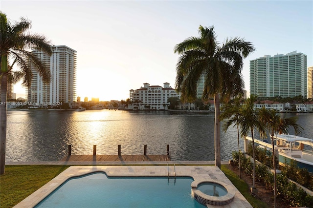 view of pool featuring a community hot tub and a water view