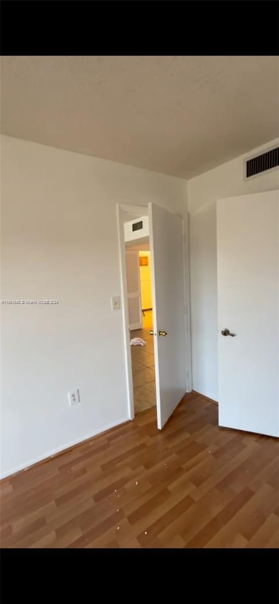 spare room featuring hardwood / wood-style flooring