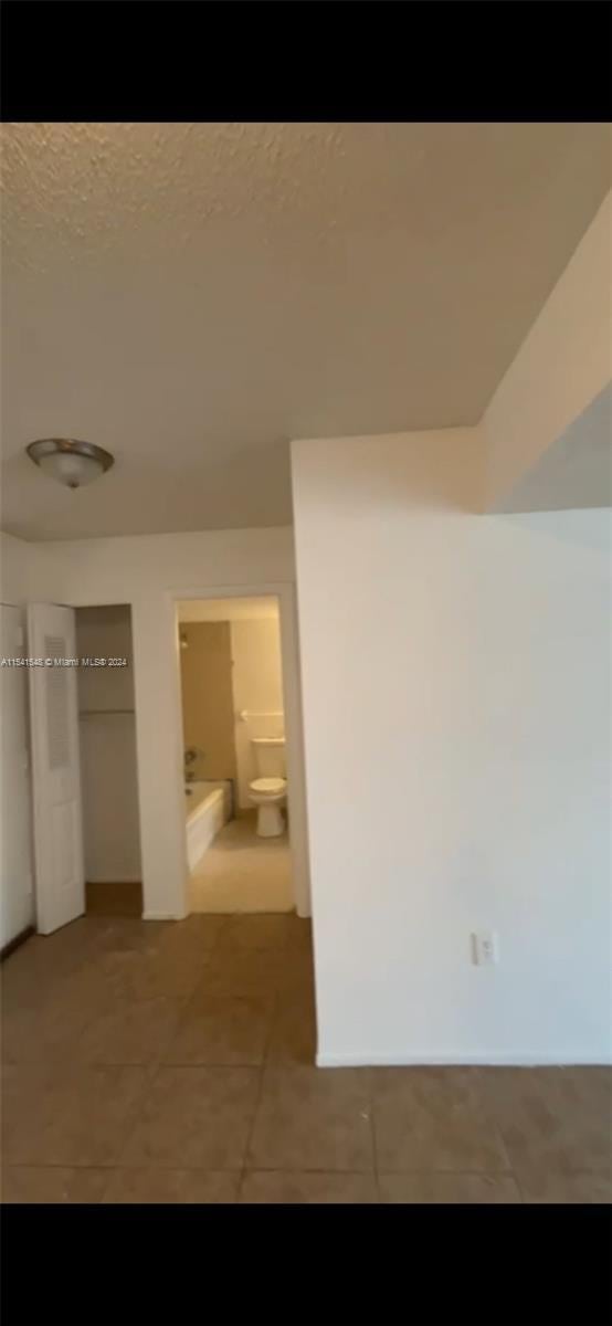 hall featuring tile patterned flooring