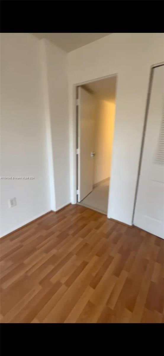 empty room with hardwood / wood-style floors