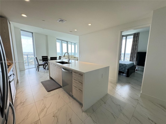 kitchen featuring sink, dishwasher, and light tile flooring