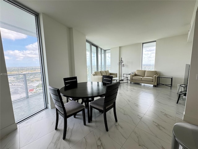 tiled dining space with expansive windows and a healthy amount of sunlight