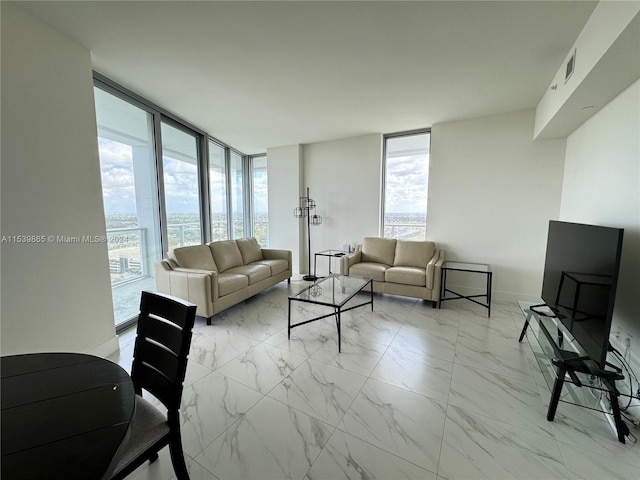 living room with a wall of windows and light tile floors