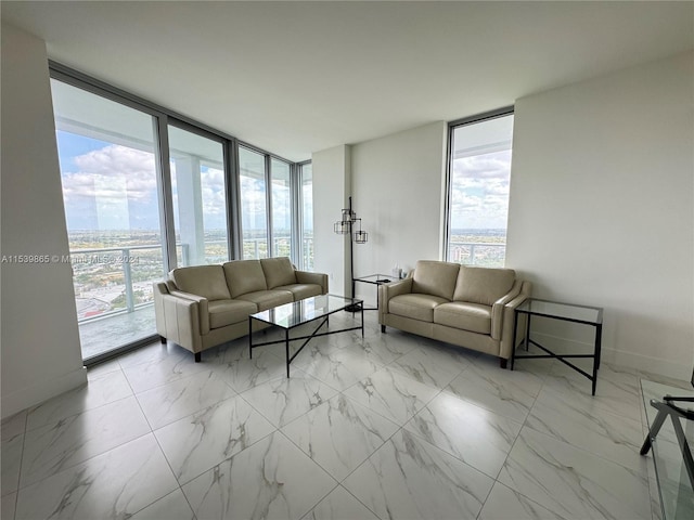 living room with plenty of natural light, expansive windows, and light tile flooring