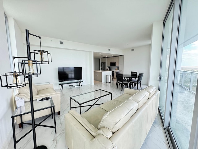 tiled living room featuring sink