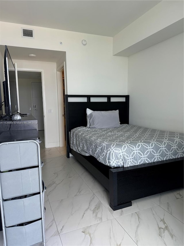 bedroom with light tile floors