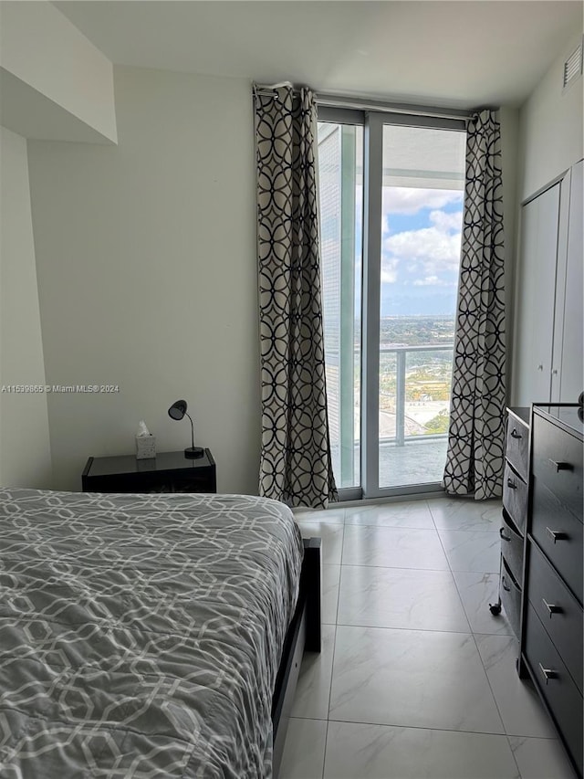 bedroom featuring light tile floors and multiple windows