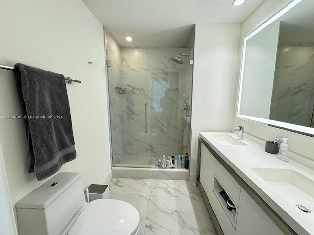 bathroom featuring a shower with door, tile flooring, toilet, and dual bowl vanity