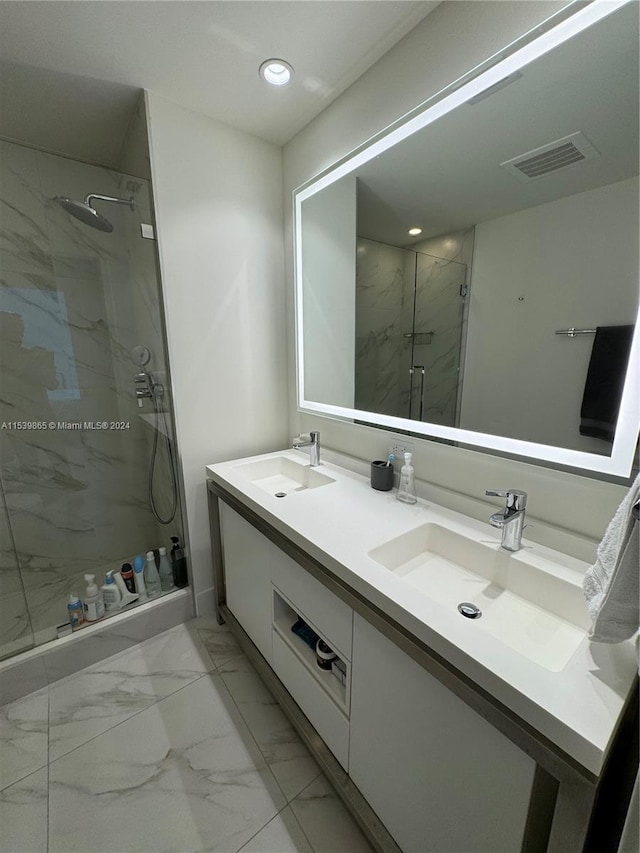 bathroom with dual bowl vanity, tile floors, and an enclosed shower