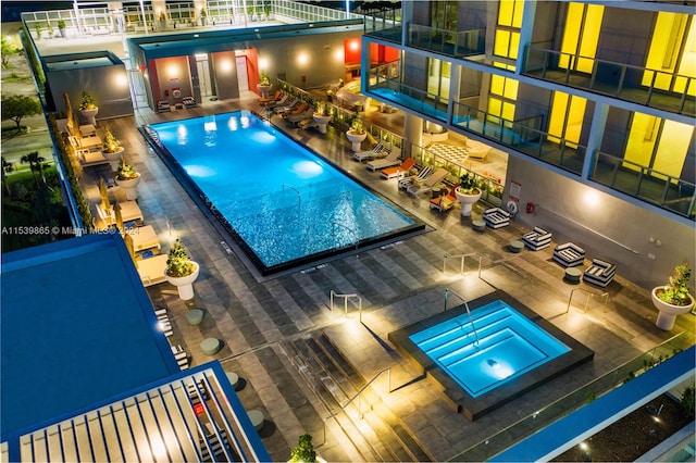 view of swimming pool with a patio area and a community hot tub