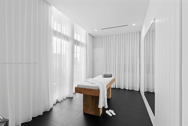 bedroom with dark tile floors